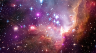 Colorful image of a stellar nebula featuring bright stars, clouds of gas, and dust illuminated in shades of purple, pink, and orange